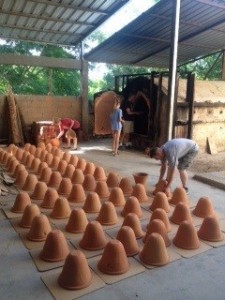 Clay filters being removed from the wood-fired kiln. 